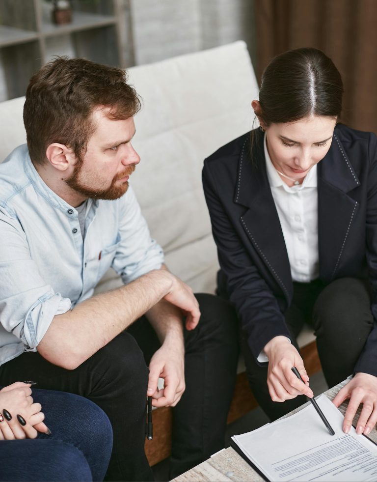 Business professionals in a meeting reviewing significant documents in an office setting.